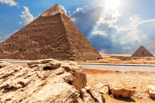 The Pyramid of Chephren, the Pyramid of Menkaure, view from the road in the desert.