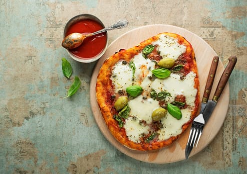 Pizza Margherita served with mozzarella cheese, tomato sauce and fresh basil