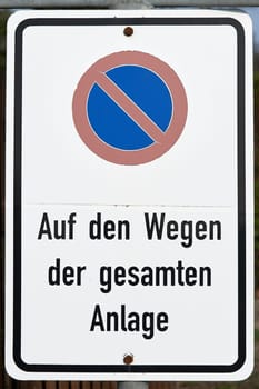 No parking sign with the note "No parking on the paths of the entire area"""