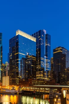 City of Chicago downtown and Chicago River sunset night in Chicago Illinois USA.