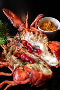 Grilled boston lobster serve with butter chilli sauce with lemon and salt.