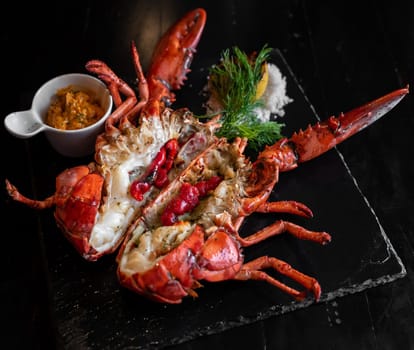 Grilled boston lobster serve with butter chilli sauce with lemon and salt.