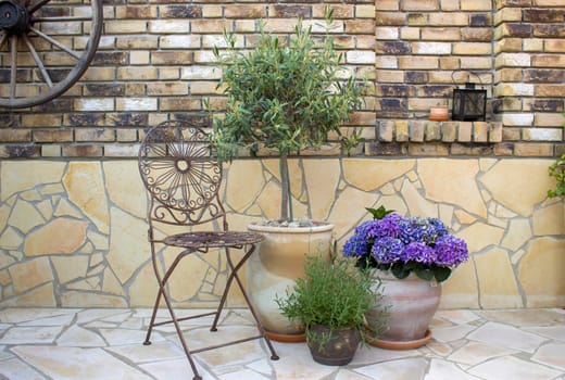 beautiful place in the garden in the mediterranean style, pots with flowers