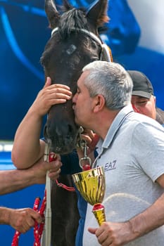 PYATIGORSK, RUSSIA - JUNE 23,2019: The winners horse race of the traditional prize "Avins wuda"" - Chomayev A.D. and purebred brown stallion Rotor on Pyatigorsk hippodrome,Northern Caucasus,Russia."