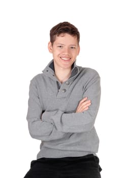 .An smiling young handsome teenage boy sitting in a gray sweater with.his arms crossed, isolated for white background.