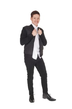 A happy young teen boy standing smiling is a black jacket and pants.with black dress shoos, isolated for white background.