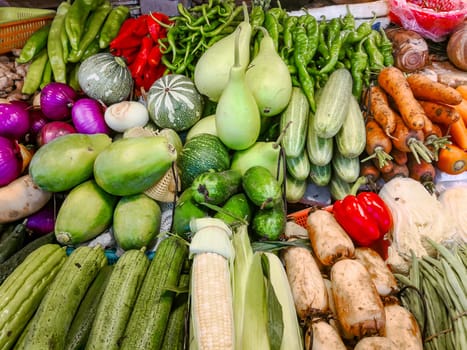 A counter with fresh vegetables in a Chinese market, farm products, greens and vegetables