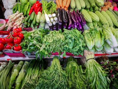 Fresh greens with vegetables on the counter, on the farmers market in China, Shenzhen