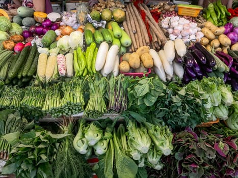 Fresh greens with vegetables on the counter, on the farmers market in China, Shenzhen