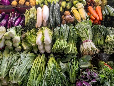 Fresh greens with vegetables on the counter, on the farmers market in China, Shenzhen