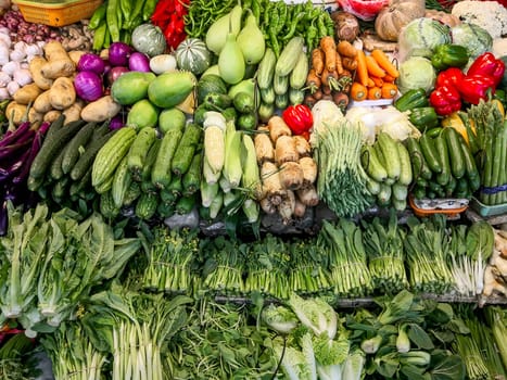 Fresh greens with vegetables on the counter, on the farmers market in China, Shenzhen