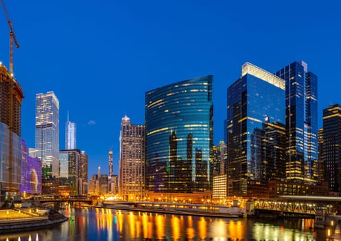 Panorama shot of City of Chicago downtown and Chicago River sunset night in Chicago Illinois USA.