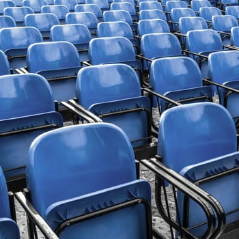 Empty plastic blue chairs In outdoor theater