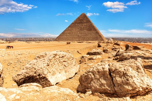 The Pyramid of Cheops and stones in the desert of Giza, Egypt.