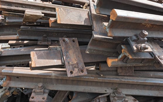 old rusty railroad tracks for scrapping in a warehouse space
