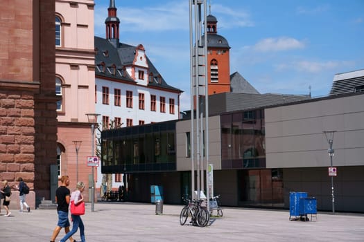 Mainz, Germany - May 27, 2019: Shops and passers-by in good weather on the Gutenbergplatz on May 27, 2019 in Mainz..