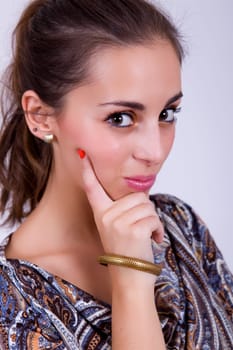 young happy beautiful woman on a grey background
