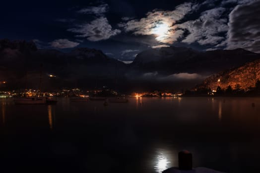 lake and mountain night with some boats