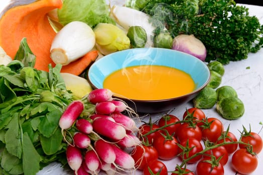 plate of pumpkin soup with  several vegetables