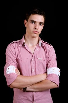 young casual man against a black background
