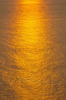 Sunset The sea surface reflects the sunlight in gold.