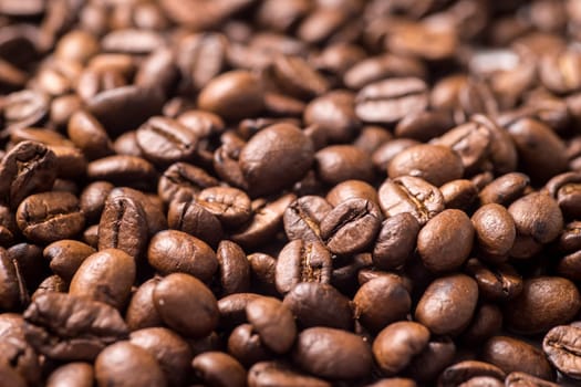 Roasted organic whole dark coffee beans, close up