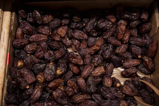 A close-up shot of an abundance of fresh Dates on display at a market stall.