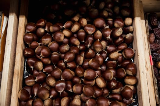 A close-up shot of an abundance of fresh Hazelnuts on display at a market stall.