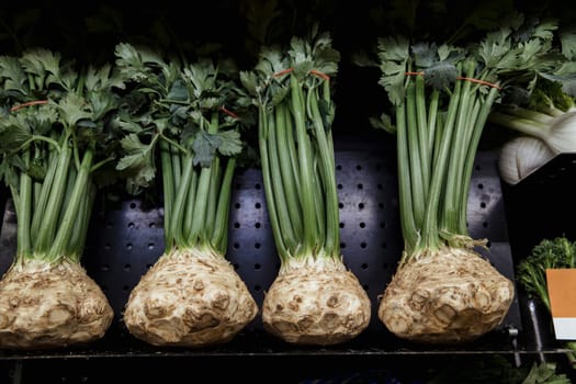A close-up shot of an abundance of fresh celery on display at a market stall.