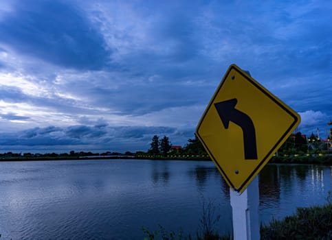 The signs on the left curve point towards the clouds..The sky after the sunset