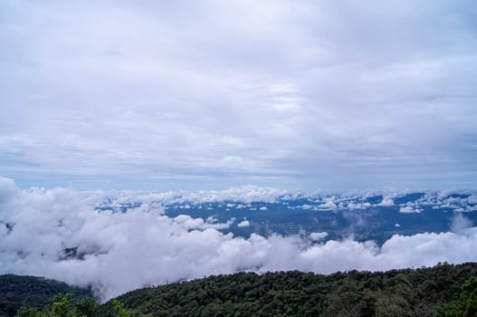 Green mountain scenery, fog in the mountains .The sky is covered with white clouds.