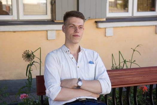 Young man sitting on bench in outdoors