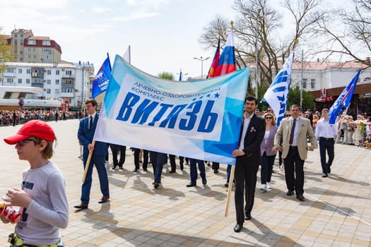 Anapa, Russia - May 1, 2019: Festive May Day demonstration with a poster "medical and health complex Vityaz"" in the resort town of Anapa"