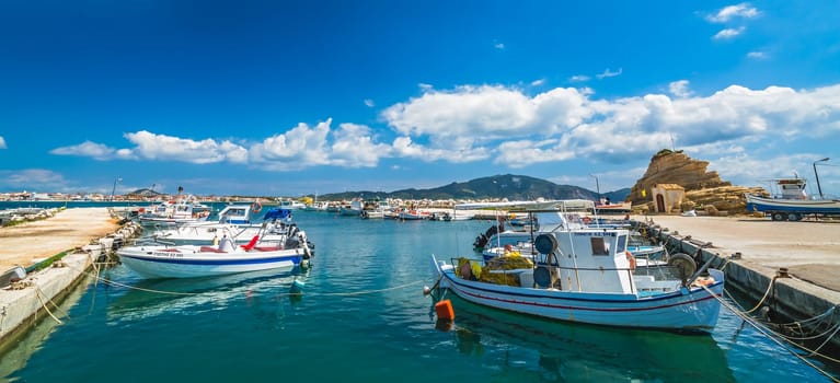 Zakynthos, Greece -  April 2019 : Small fishermen boats and speed and fast private motorboats moored in the Laganas port