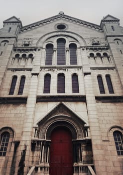 Side door and facade of Sacre Coeur Cathedral on Montmartre , Paris, France.