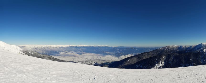 Mountains view to the winter sky slope resort from the top of Todorka peak in Bansko, Bulgaria