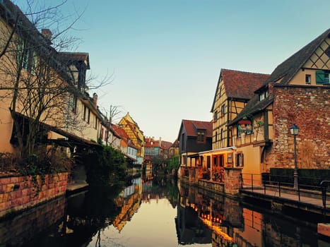 Autumn evening in colorful romantic city Colmar, France, Alsace. Traditional houses near the river. Medieval home facade, historic town. Beautiful idyllic architecture.