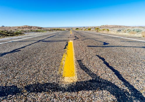View of an endless straight road running through the desert in the USA