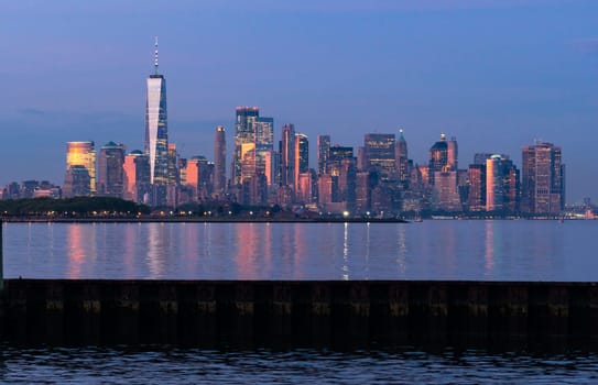 Dusk light reflects off the buildings onto Hudson Bay at sunset in Manhattan