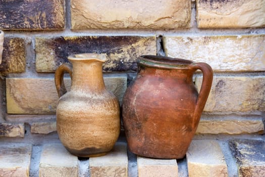 clay pots on a brick wall