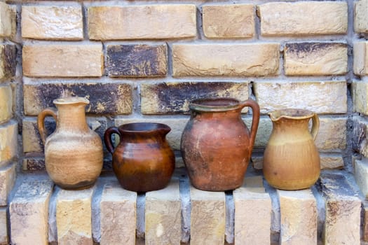 clay pots on a brick wall