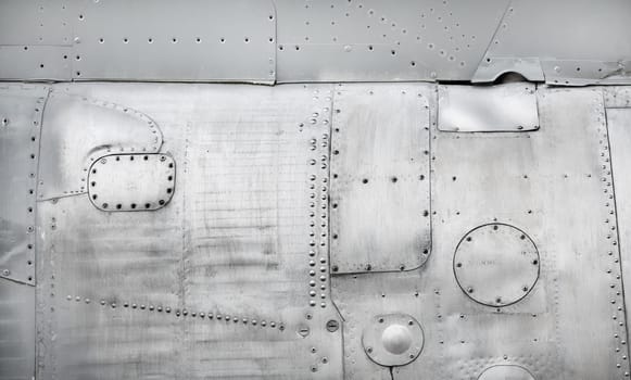 Old metal background. Weathered metallic texture with rivets and bolts.