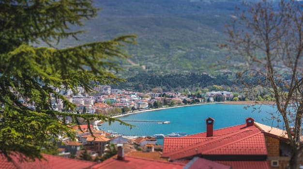 Panoramic image of hillside red tiled rooftops of houses on the shore of Lake Ohrid, Northern Macedonia