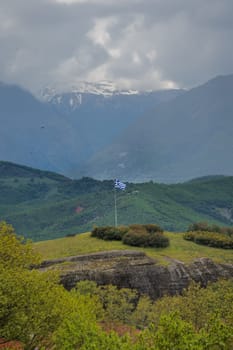 Greek flag on a tall mast pole on the hill in Kastraki village in Meteora, northern Greece