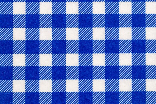 Textile background texture. Top view of details of a empty blue and white checkered kitchen cloth, textile, tablecloth or napkin. Template for food and product display montage. Macro.