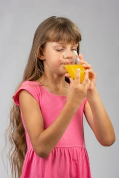 Girl drinking orange juice from a glass