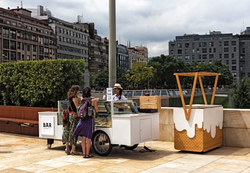 ice cream vendors and customers in the downtown area of ​​bilbao spain