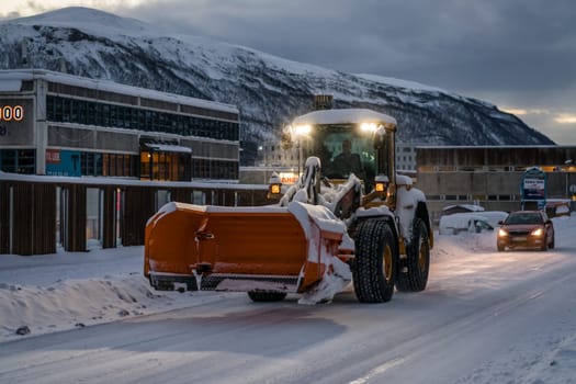 Tromso, Norway -  December 2018 : Powerful snowplough clearing residential roads in Tromso town in winter