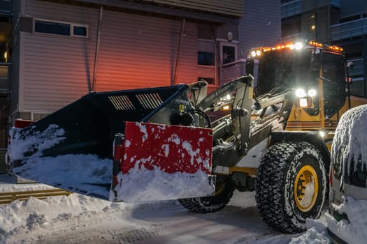 Tromso, Norway -  December 2018 : Powerful snowplough clearing residential roads in Tromso town in winter