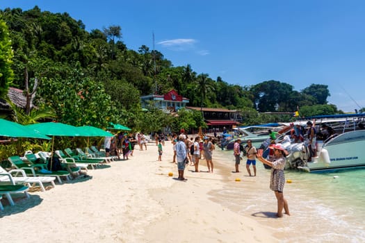 Phi Phi Don island, Thailand, March 2013 Crowds of tourists arrived and departing from boats, enjoying a trip, one of the iconic beaches of Phi Phi islands